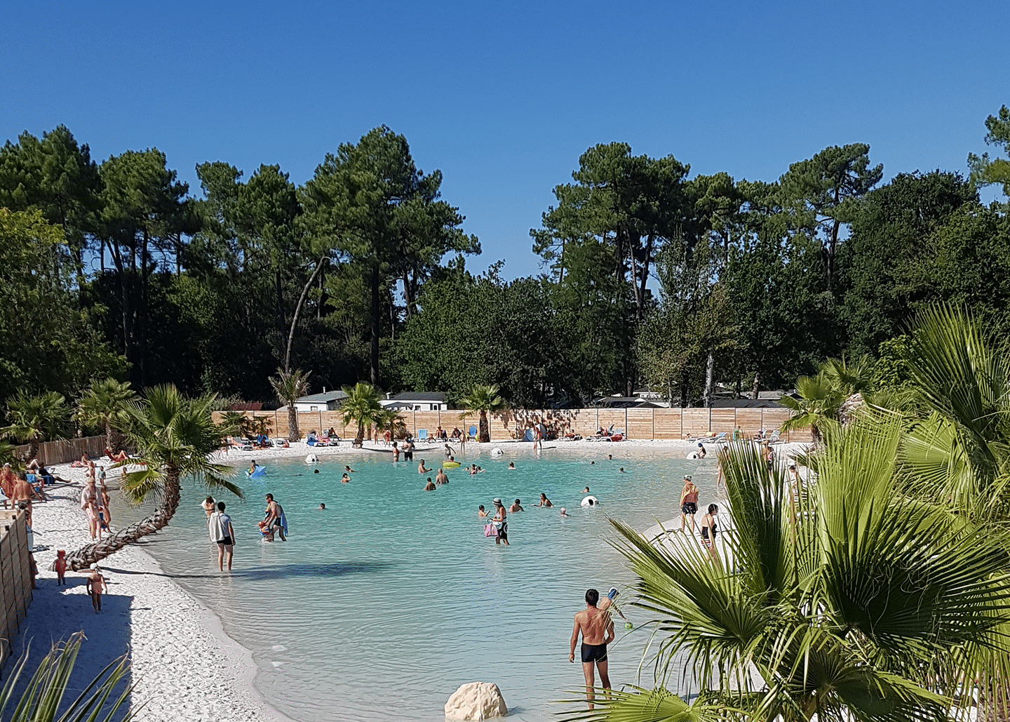 Familles profitant d'une plage artificielle ensoleillée.